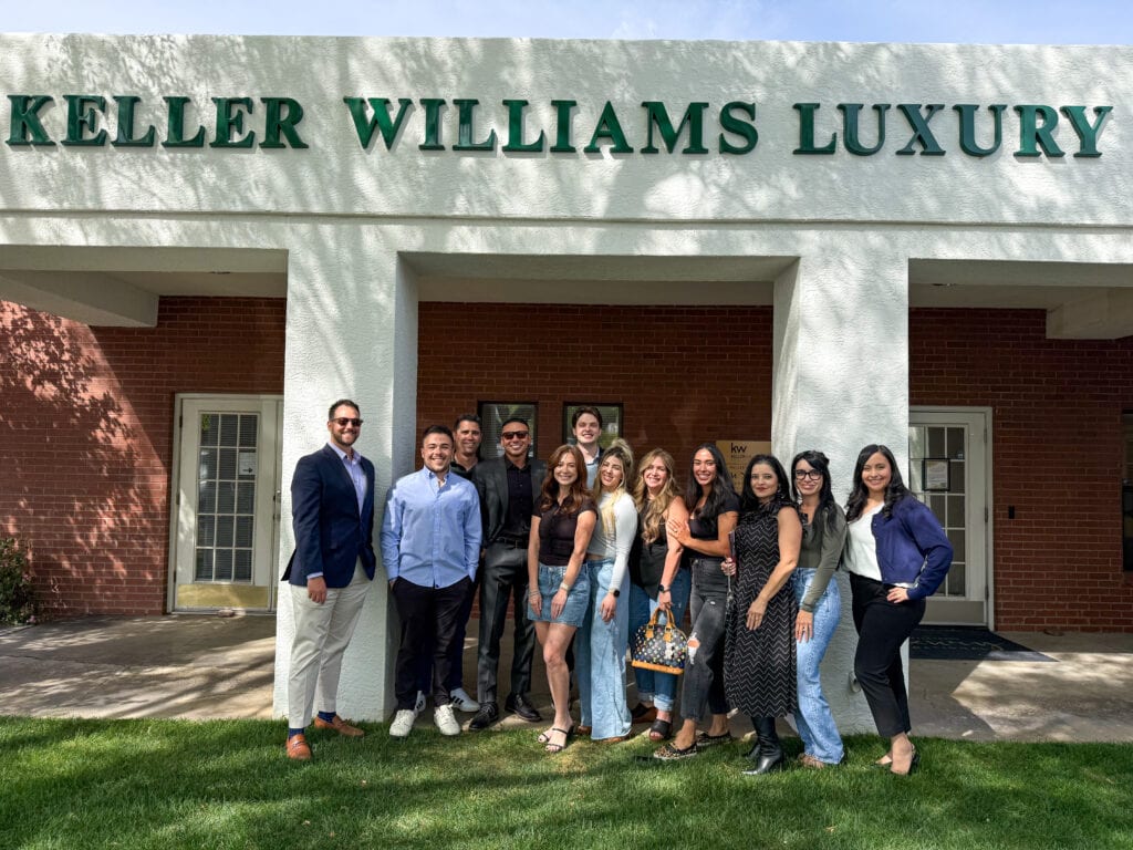 Jeremy Navarro Realty Group team posing outside Keller Williams luxury building, showcasing professional real estate services and expertise in luxury home sales and marketing.